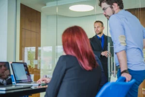 Customers waiting in a high-traffic service environment while staff manage queue operations